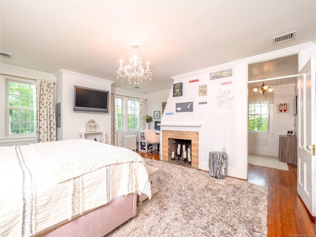 304 Main St, Ridgefield, CT 06877 - bedroom with a chandelier, radiator, crown molding, wood finished floors, and multiple windows