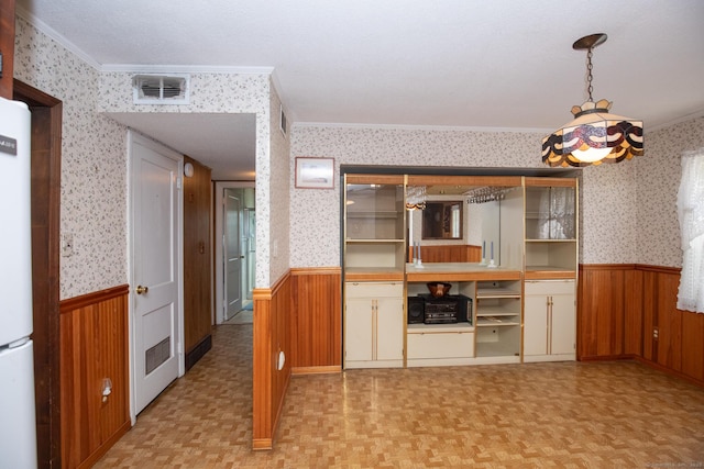 7 Cheryl Ave, Wallingford, CT 06492 - kitchen with a wainscoted wall, ornamental molding, wallpapered walls, freestanding refrigerator, and wood walls