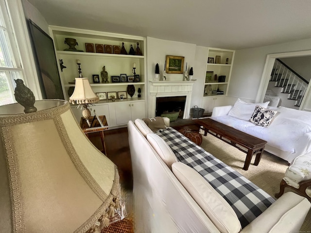 118 Sanfordtown Rd, Redding, CT 06896 - living room featuring built in shelves, a fireplace, and stairs
