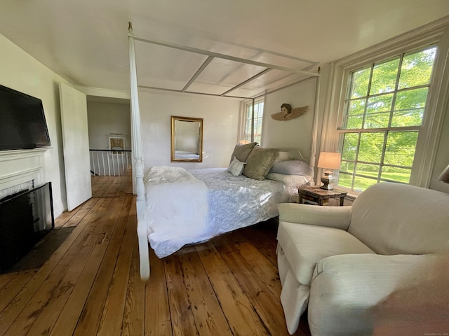 118 Sanfordtown Rd, Redding, CT 06896 - bedroom with dark wood-style flooring and a fireplace with flush hearth