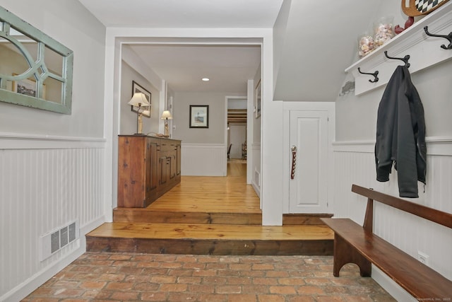11 Ledgewood Rd, Redding, CT 06896 - mudroom featuring a wainscoted wall and brick floors