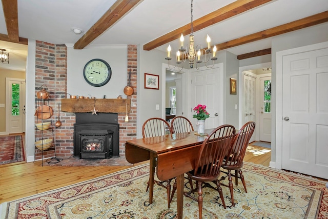 11 Ledgewood Rd, Redding, CT 06896 - dining space featuring a chandelier, hardwood / wood-style floors, beamed ceiling, and a wood stove
