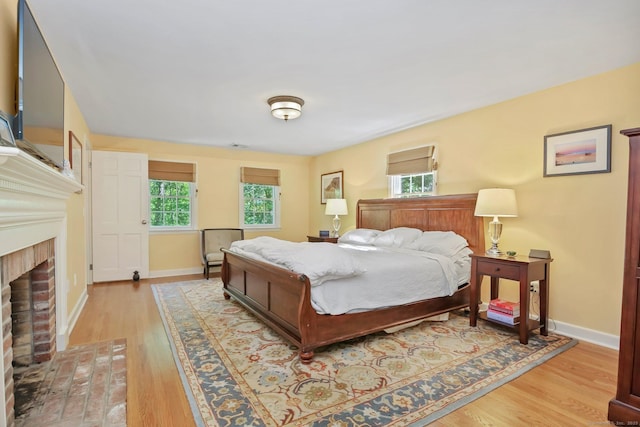 11 Ledgewood Rd, Redding, CT 06896 - bedroom with a fireplace, light wood-style flooring, and baseboards
