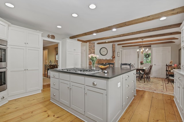 11 Ledgewood Rd, Redding, CT 06896 - kitchen with light wood finished floors, white cabinets, stainless steel gas stovetop, dark countertops, and beamed ceiling