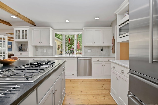 11 Ledgewood Rd, Redding, CT 06896 - kitchen with stainless steel appliances, light wood finished floors, white cabinetry, backsplash, and recessed lighting