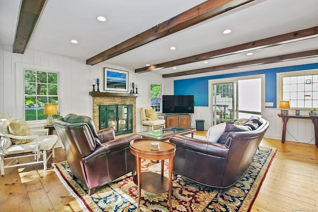 11 Ledgewood Rd, Redding, CT 06896 - living area featuring hardwood / wood-style floors, a glass covered fireplace, beamed ceiling, a decorative wall, and recessed lighting