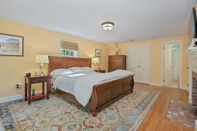 11 Ledgewood Rd, Redding, CT 06896 - bedroom featuring a fireplace, wood finished floors, and baseboards