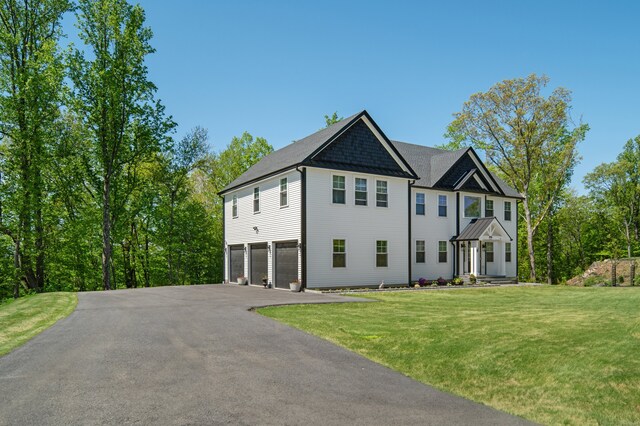 26 Hunting Ridge Rd, Brookfield, CT 06804 - view of front of house with driveway, a garage, and a front yard