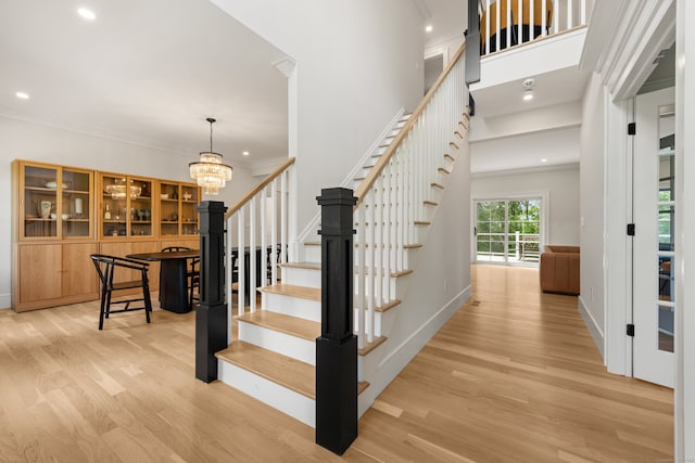 26 Hunting Ridge Rd, Brookfield, CT 06804 - stairs with wood finished floors, a chandelier, baseboards, recessed lighting, and ornamental molding