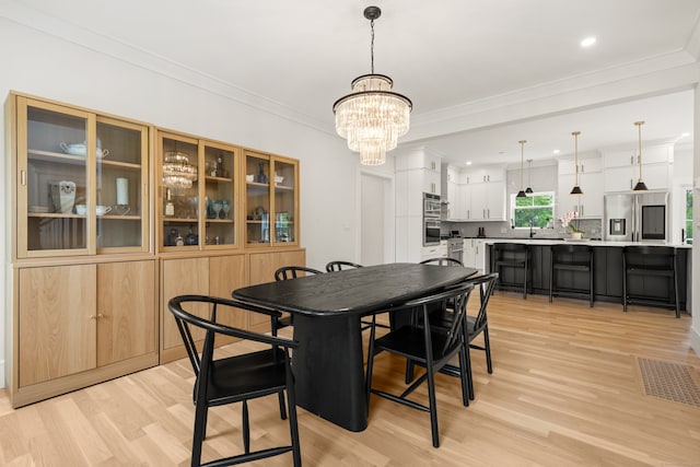 26 Hunting Ridge Rd, Brookfield, CT 06804 - dining space featuring light wood-style floors, a chandelier, crown molding, and recessed lighting