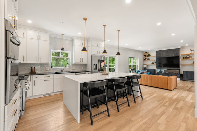 26 Hunting Ridge Rd, Brookfield, CT 06804 - kitchen featuring appliances with stainless steel finishes, a sink, healthy amount of natural light, backsplash, and ornamental molding