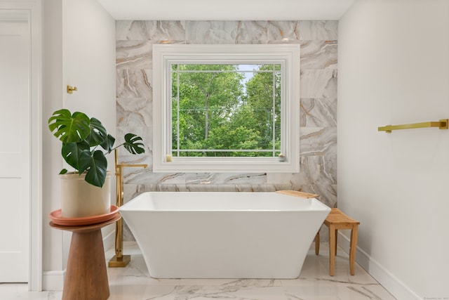 26 Hunting Ridge Rd, Brookfield, CT 06804 - bathroom featuring a freestanding tub, marble look tiles, and baseboards