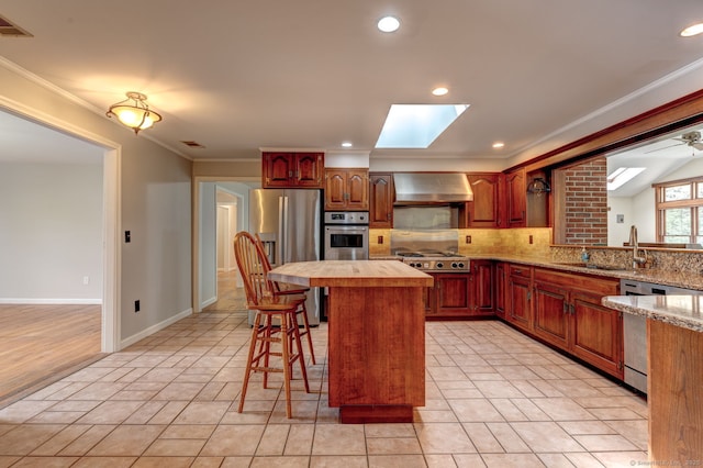 3 Clear View Dr, Mansfield, CT 06250 - kitchen featuring appliances with stainless steel finishes, wall chimney range hood, a sink, a skylight, and decorative backsplash