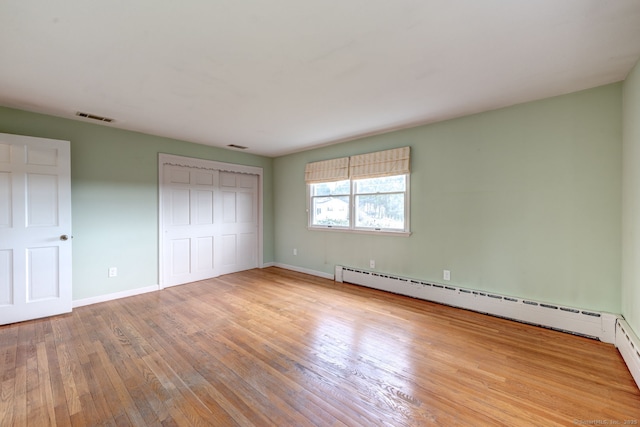 3 Clear View Dr, Mansfield, CT 06250 - unfurnished bedroom with wood-type flooring, baseboards, a closet, and a baseboard heating unit