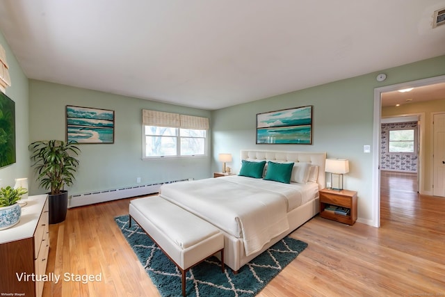 3 Clear View Dr, Mansfield, CT 06250 - bedroom featuring a baseboard heating unit, light wood finished floors, multiple windows, and baseboards