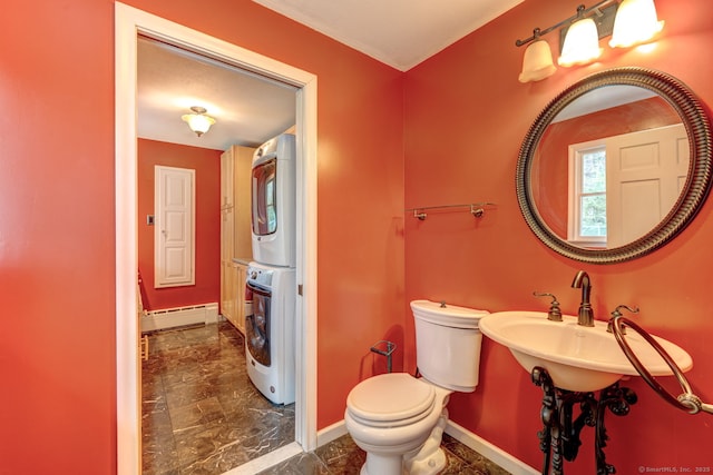 3 Clear View Dr, Mansfield, CT 06250 - half bathroom with estacked washer and dryer, toilet, baseboards, and a baseboard radiator