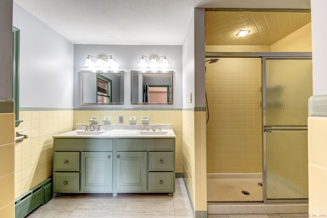 3 Clear View Dr, Mansfield, CT 06250 - bathroom featuring baseboard heating, a shower stall, tile walls, double vanity, and tile patterned flooring