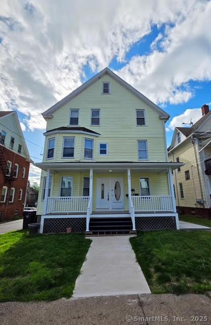 93 S Burritt St, New Britain, CT 06052 - view of front of home with covered porch and a front lawn