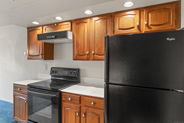 50 Aiken St Apt 465, Norwalk, CT 06851 - kitchen with black appliances, under cabinet range hood, light countertops, brown cabinetry, and recessed lighting