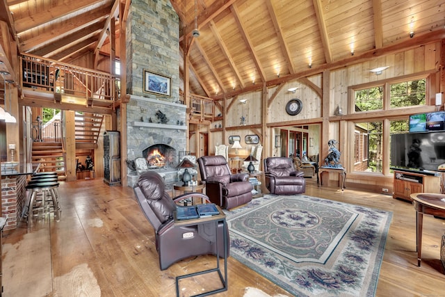 218 Kuhne Rd, Southbury, CT 06488 - living room with high vaulted ceiling, wood ceiling with exposed beams, light wood-style floors, stairway, and a fireplace