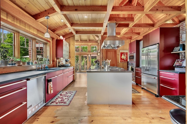 218 Kuhne Rd, Southbury, CT 06488 - kitchen featuring appliances with stainless steel finishes, wall chimney range hood, a sink, light wood-style floors, and stainless steel countertops