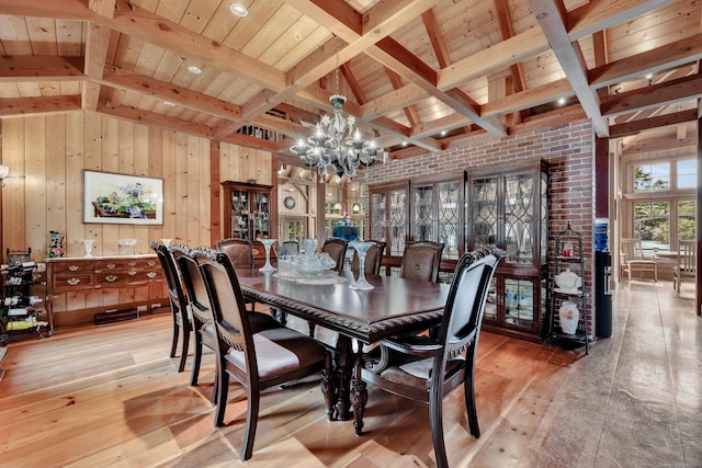 218 Kuhne Rd, Southbury, CT 06488 - dining room featuring light wood finished floors, a chandelier, wooden walls, and wooden ceiling