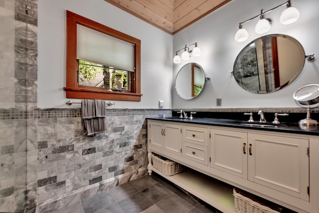 218 Kuhne Rd, Southbury, CT 06488 - bathroom with tile walls, double vanity, tile patterned floors, and a wainscoted wall