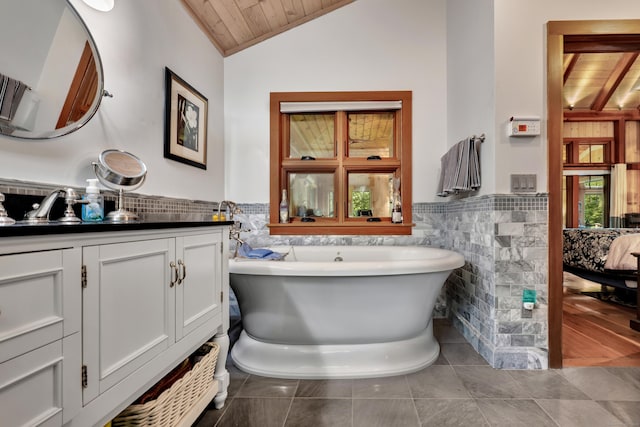218 Kuhne Rd, Southbury, CT 06488 - full bathroom featuring tile walls, wood ceiling, a soaking tub, wainscoting, and vanity