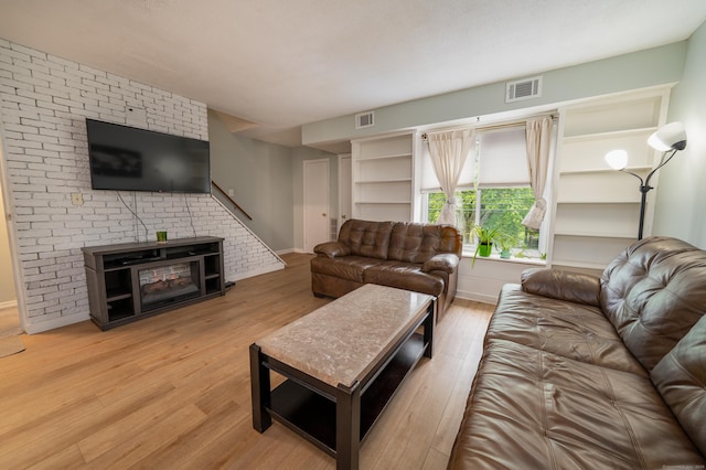 183 Thompson St Unit B, East Haven, CT 06513 - living area with wood finished floors, a fireplace, and baseboards