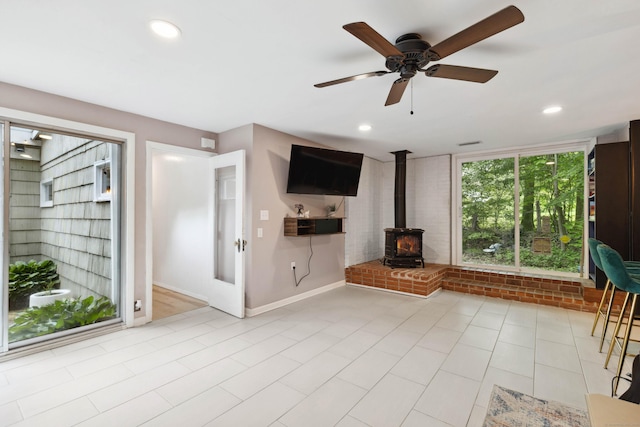 35 Old Acres Rd, East Haddam, CT 06469 - unfurnished living room with a wood stove, a ceiling fan, baseboards, and recessed lighting