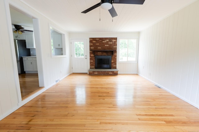 38 Dinwoodie Dr, North Branford, CT 06471 - unfurnished living room with ceiling fan, light wood finished floors, and a brick fireplace