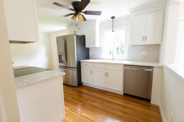 38 Dinwoodie Dr, North Branford, CT 06471 - kitchen featuring appliances with stainless steel finishes, a sink, decorative backsplash, ornamental molding, and white cabinets
