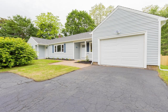 38 Dinwoodie Dr, North Branford, CT 06471 - ranch-style house with a front lawn, driveway, an attached garage, and a chimney