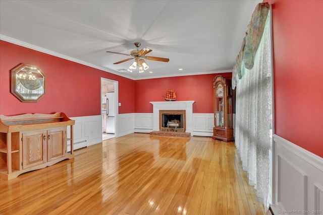 166 Mine Rd, Bristol, CT 06010 - unfurnished living room featuring a ceiling fan, a baseboard heating unit, baseboard heating, light wood finished floors, and wainscoting