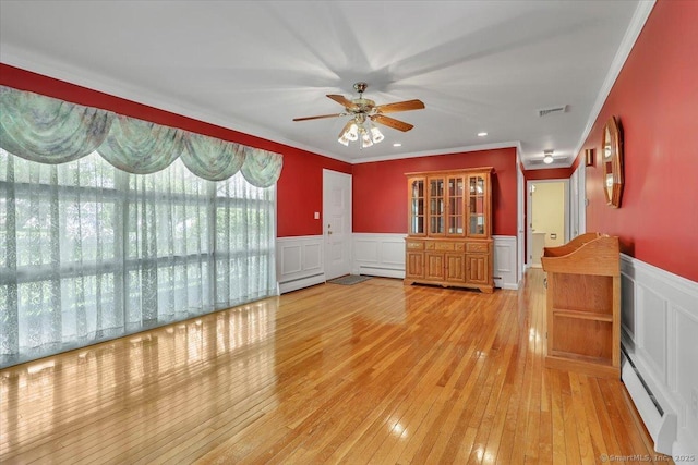 166 Mine Rd, Bristol, CT 06010 - spare room with ceiling fan, a decorative wall, wainscoting, baseboard heating, and hardwood / wood-style flooring