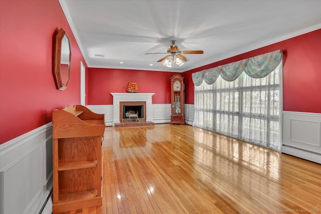 166 Mine Rd, Bristol, CT 06010 - unfurnished living room with a wainscoted wall, a ceiling fan, ornamental molding, a fireplace, and a decorative wall