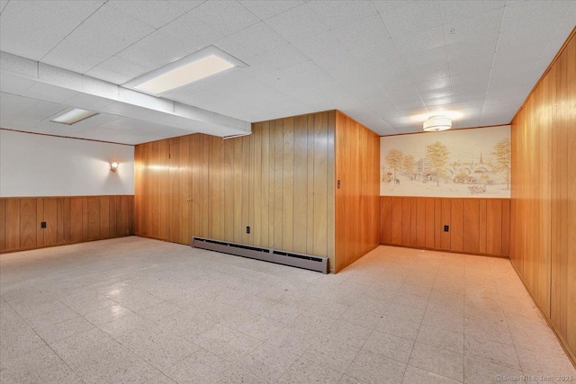 166 Mine Rd, Bristol, CT 06010 - finished basement with a baseboard radiator, wooden walls, a wainscoted wall, and tile patterned floors