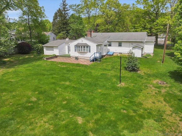 166 Mine Rd, Bristol, CT 06010 - back of house featuring a lawn, a garage, and a patio area