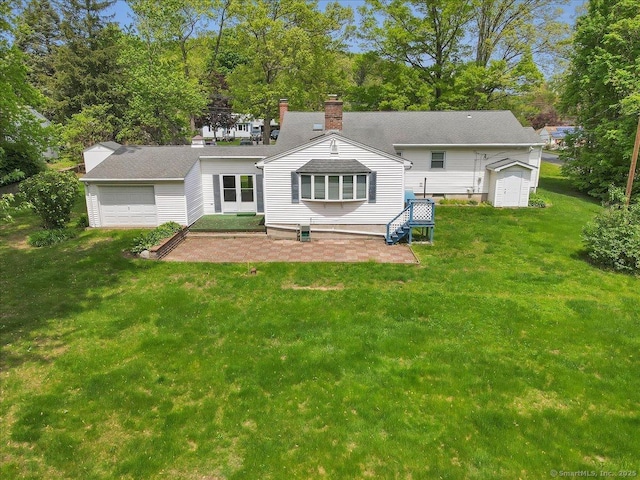 166 Mine Rd, Bristol, CT 06010 - back of house featuring a yard, a patio, and a garage
