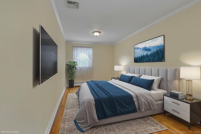 166 Mine Rd, Bristol, CT 06010 - bedroom with ornamental molding, light wood finished floors, and baseboards