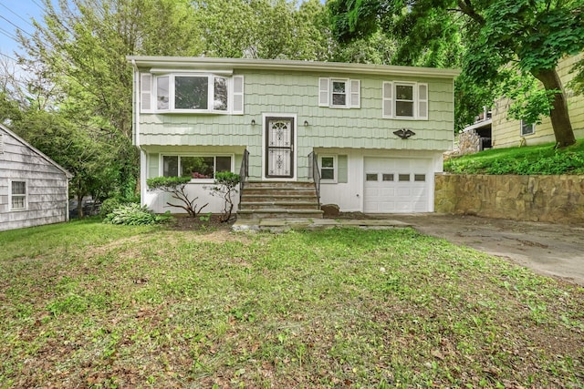 9 Marlin Dr, Norwalk, CT 06854 - split foyer home featuring an attached garage, driveway, and a front lawn