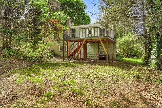 9 Marlin Dr, Norwalk, CT 06854 - back of property with stairs, a deck, and a sunroom