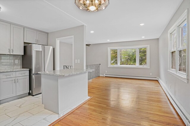 9 Marlin Dr, Norwalk, CT 06854 - kitchen with freestanding refrigerator, baseboard heating, a baseboard radiator, gray cabinets, and light stone countertops