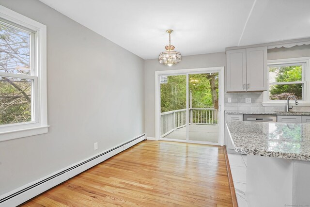 9 Marlin Dr, Norwalk, CT 06854 - unfurnished dining area featuring baseboard heating, a sink, and healthy amount of natural light