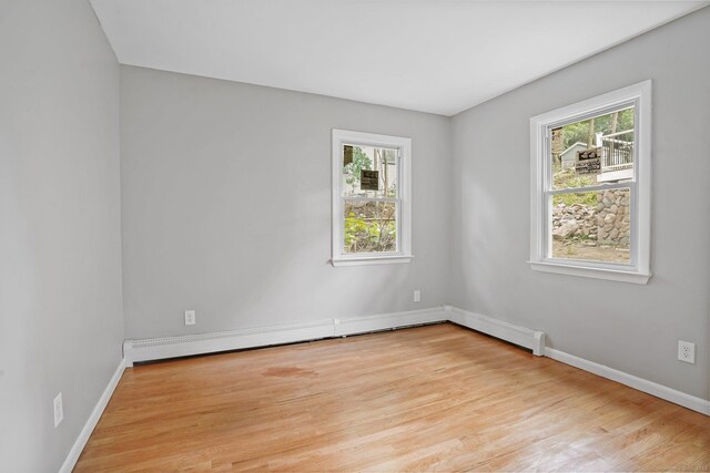 9 Marlin Dr, Norwalk, CT 06854 - empty room with light wood-style floors, healthy amount of natural light, baseboards, and a baseboard radiator