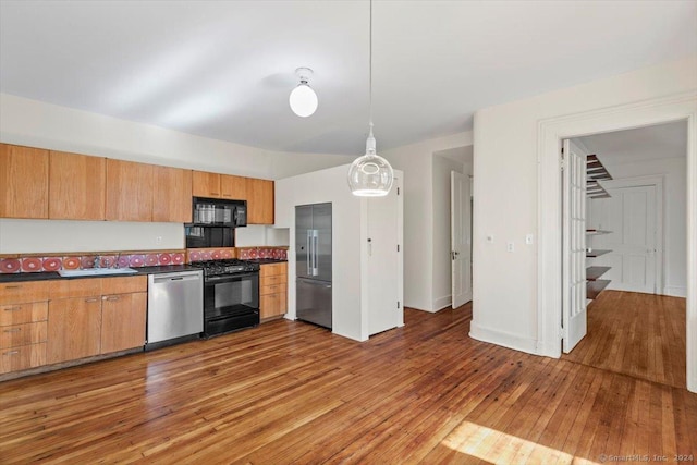 8 Academy St, New Haven, CT 06511 - kitchen with black appliances, a sink, light wood finished floors, dark countertops, and decorative light fixtures