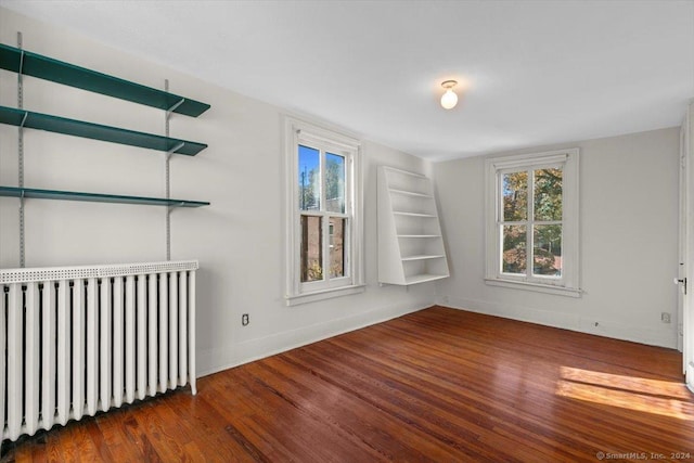 8 Academy St, New Haven, CT 06511 - empty room featuring radiator, wood finished floors, plenty of natural light, and baseboards