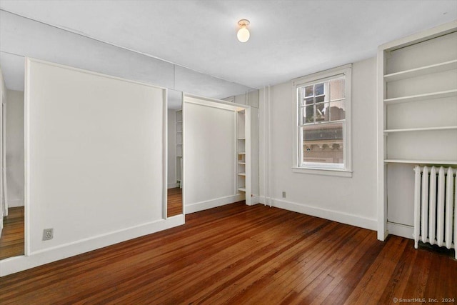 8 Academy St, New Haven, CT 06511 - unfurnished bedroom featuring radiator, hardwood / wood-style floors, baseboards, and two closets