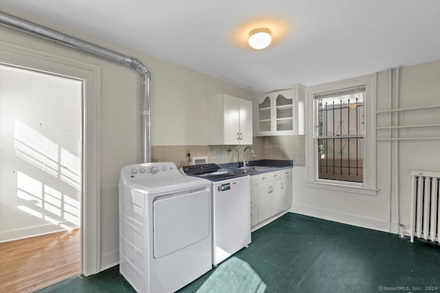 8 Academy St, New Haven, CT 06511 - laundry room with washing machine and clothes dryer, radiator heating unit, cabinet space, dark floors, and baseboards