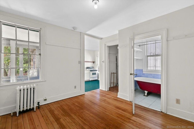 8 Academy St, New Haven, CT 06511 - unfurnished bedroom with radiator heating unit, hardwood / wood-style flooring, multiple windows, and ensuite bathroom